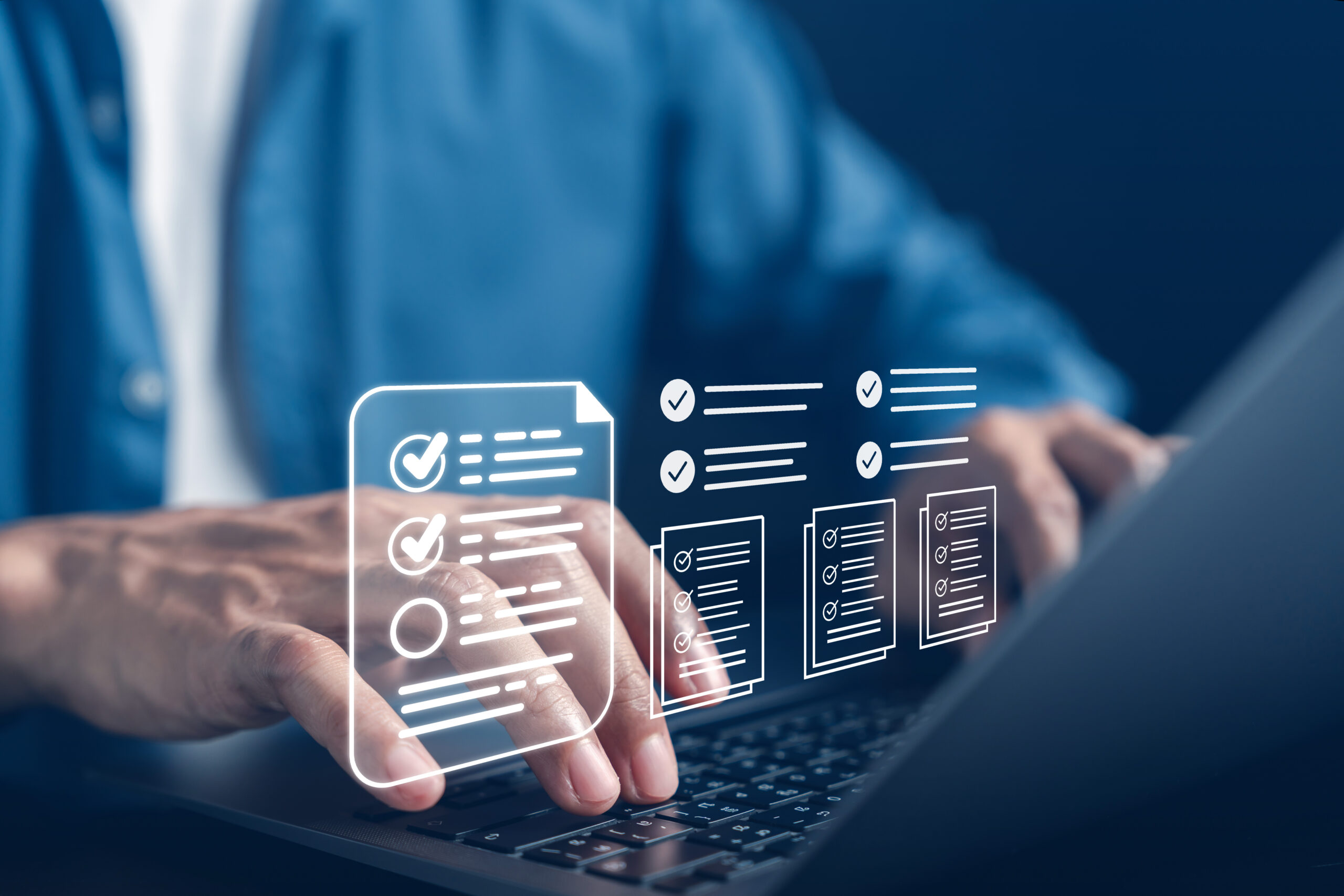 Close-up of hands typing on a laptop with digital checklist icons, symbolising automated data governance